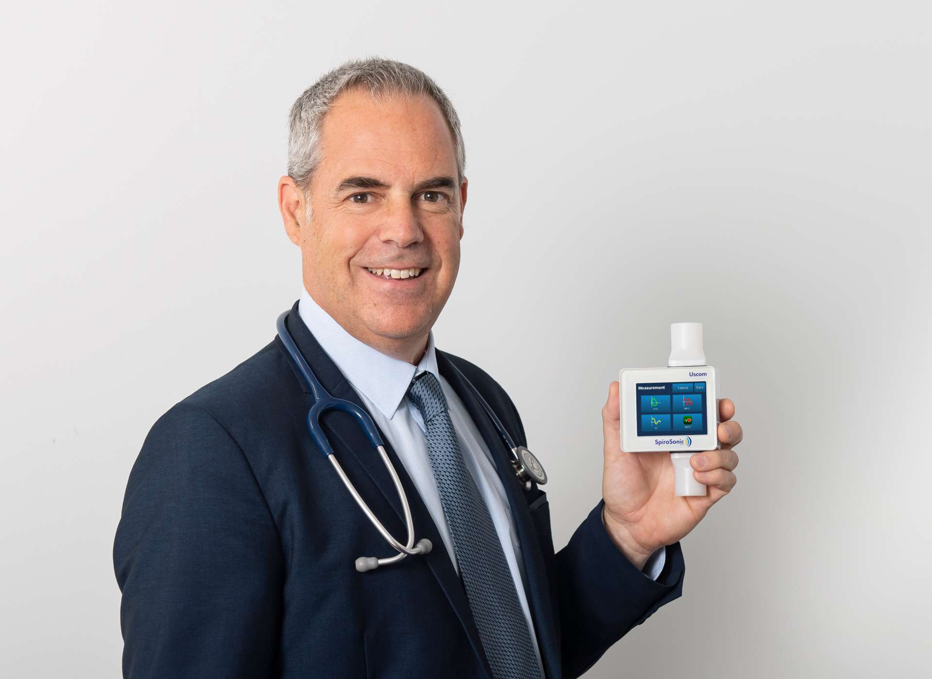SpiroSonic SMART Man holds SpiroSonic SMART ultrasonic spirometer